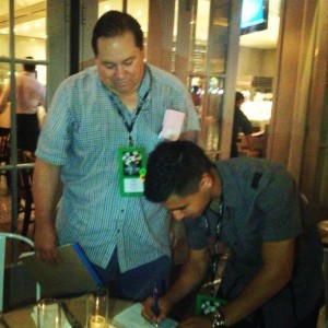 Manager Cameron  watches Alexis Zazueta sign contract