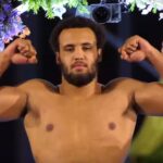 Moses Itauma flexing muscles at weigh in