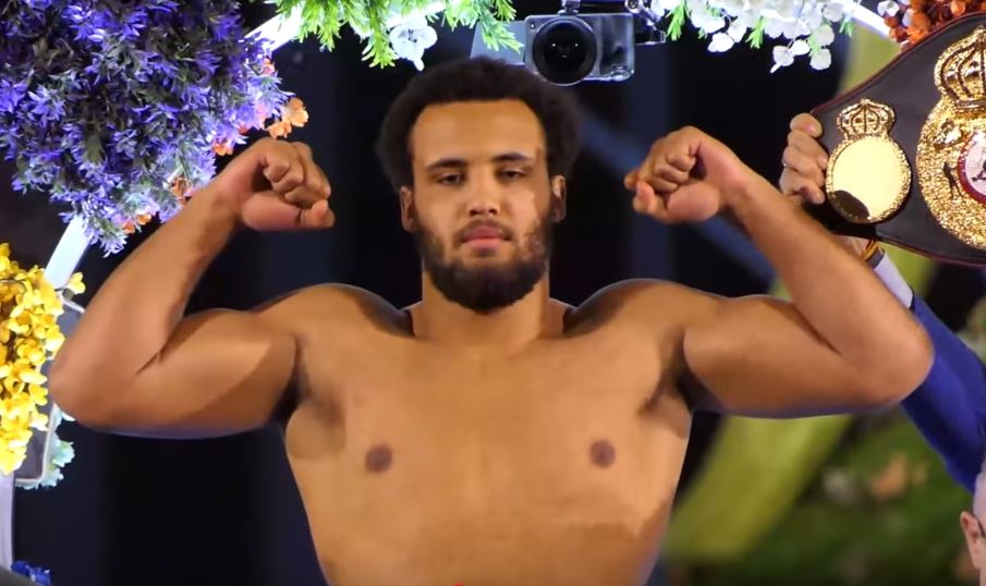 Moses Itauma flexing muscles at weigh in